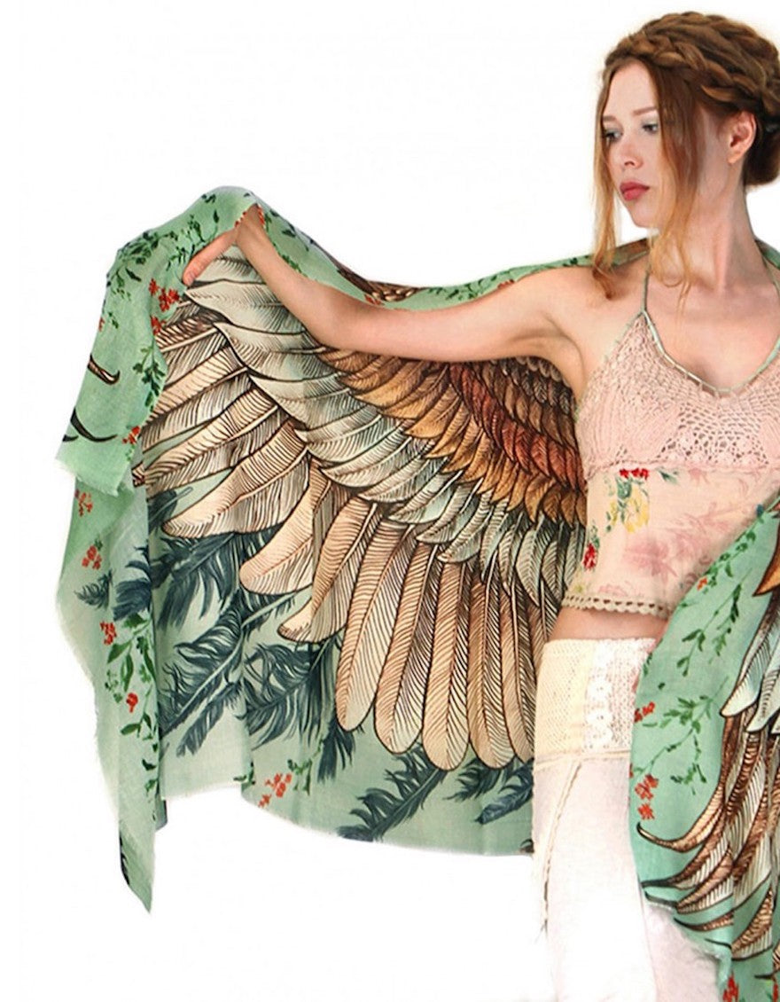 Woman wearing a beautiful shawl that looks like bird wings.